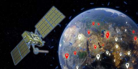 Satellite orbiting Earth with smaller satellites in the backdrop.