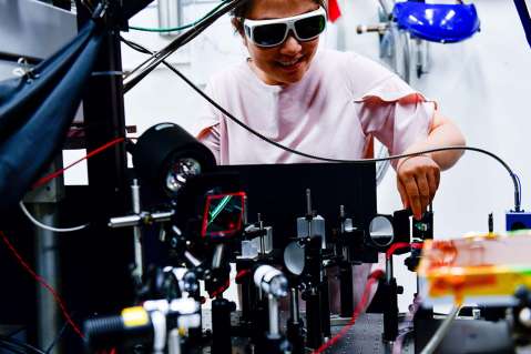 Woman sets up laser equipment