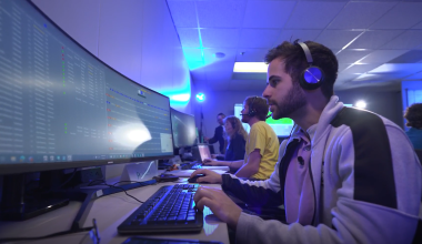 Man using a computer to participate in wargame.